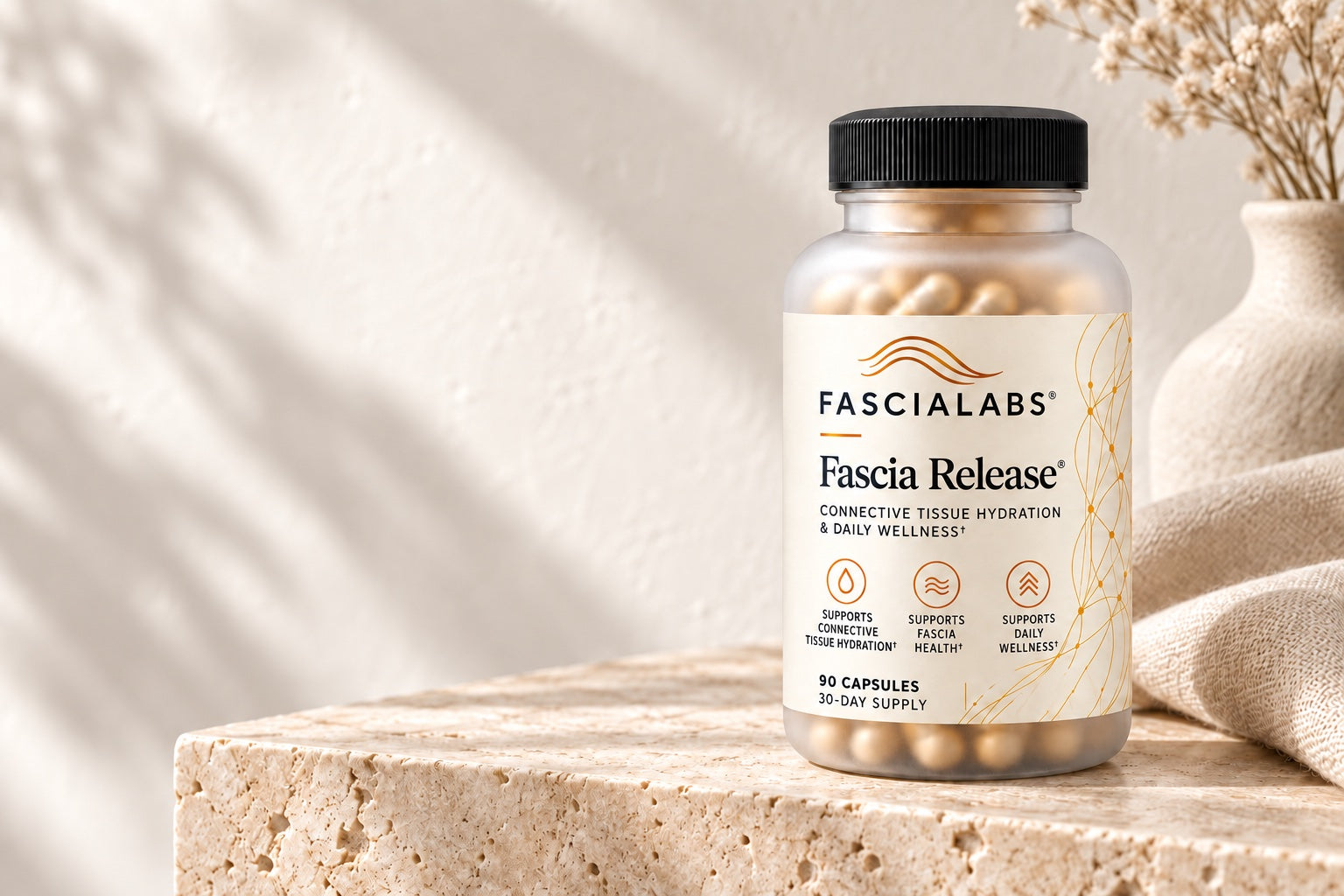 FASCIALABS Fascia Release bottle on warm stone, styled with ivory linen
