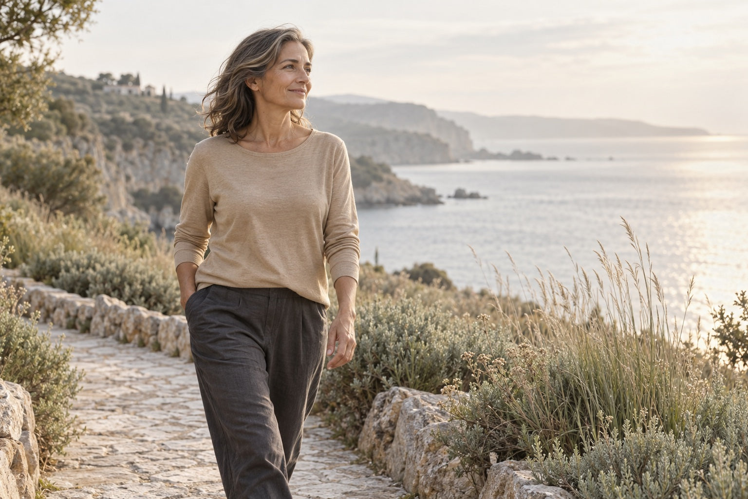 A woman enjoying a quiet walk along a sunlit coastal path